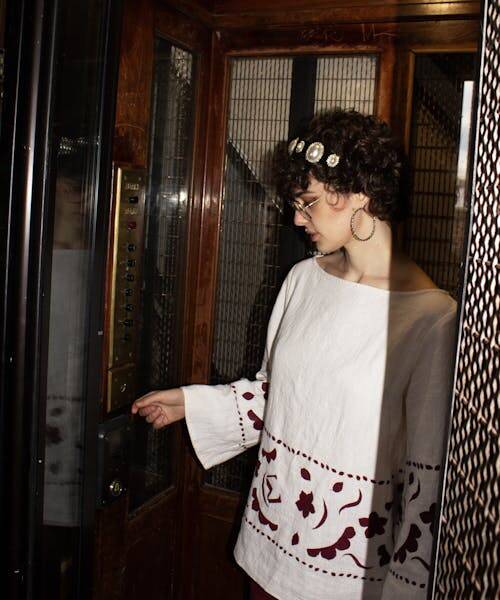 Femme portant une tunique blanche fabriquée en France par Maressang.